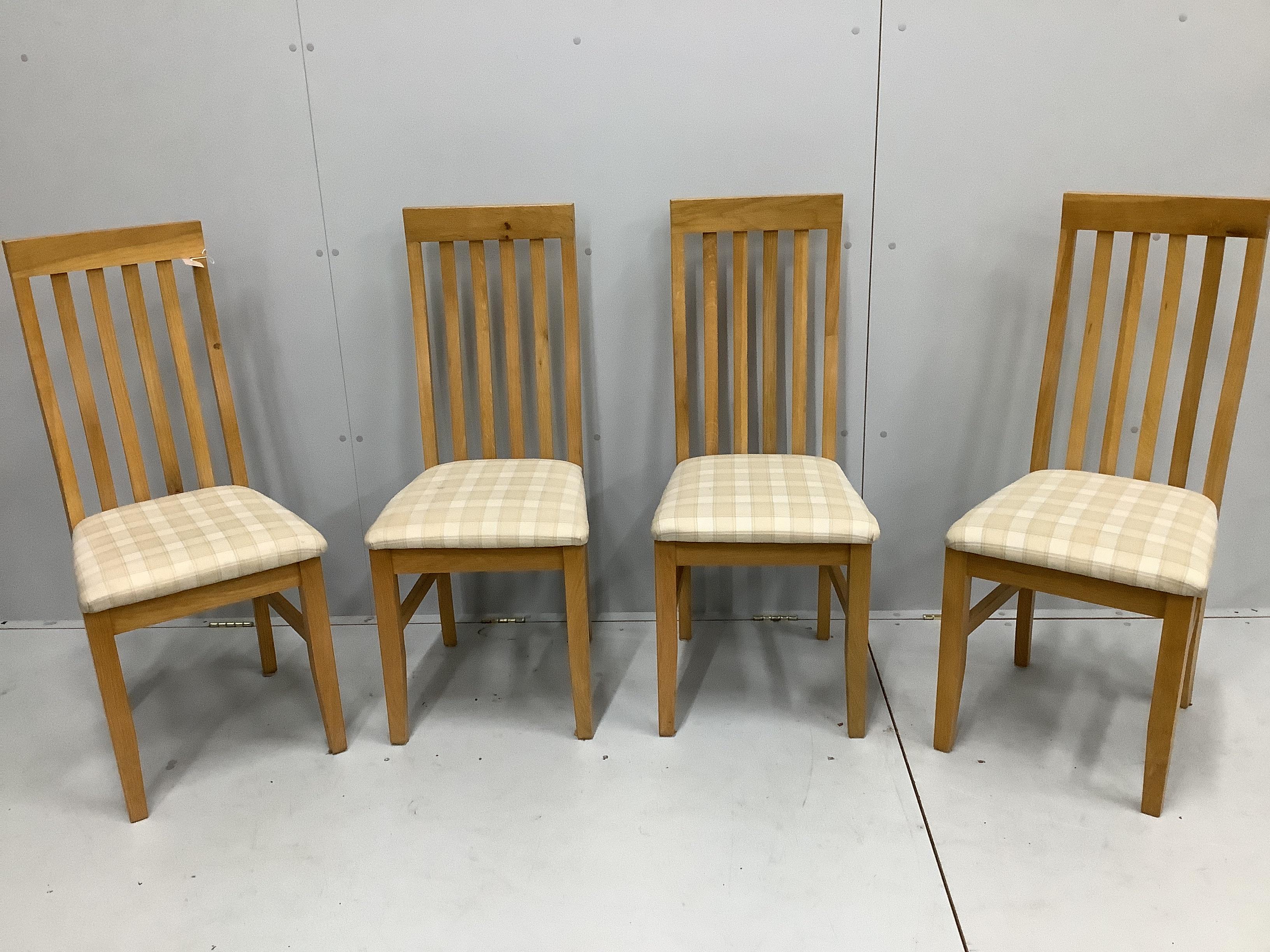 A contemporary oak draw leaf extending dining table, width 200cm extended, depth 80cm, height 78cm together with a set of four matching dining chairs